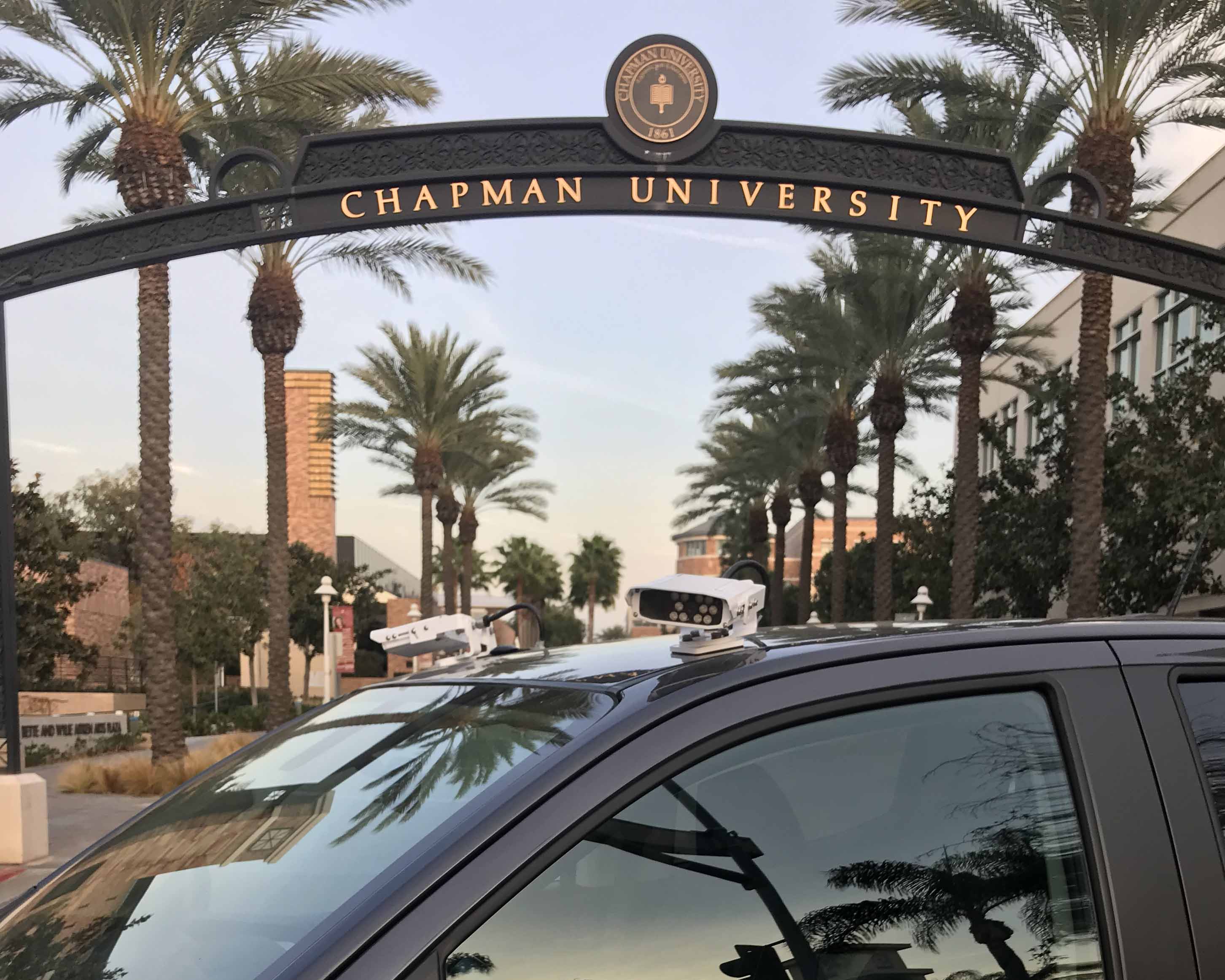 black Enforcement vehicle with two LPR cameras  in front of Chapman University entrance gate